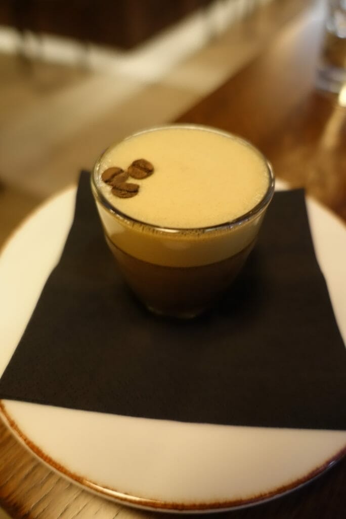 Mini espresso martini with coffee beans on top