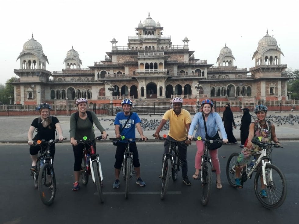 The group on bikes in front of the palace in Jaipur