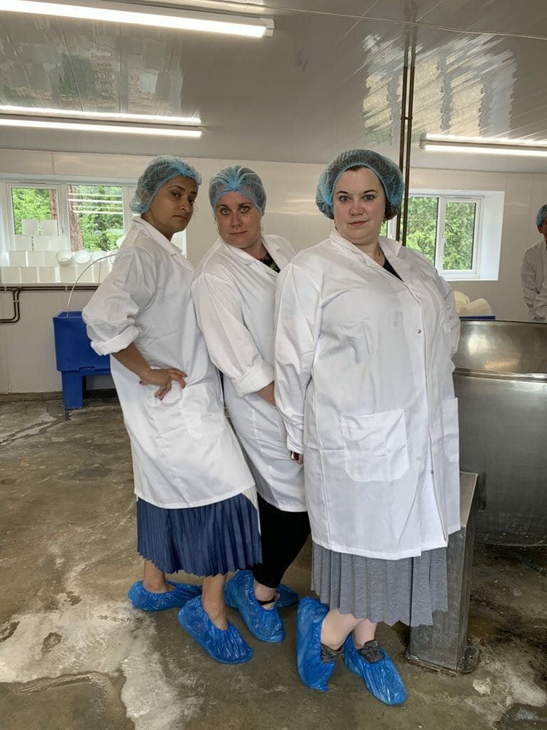 Katie's friends dressed up with hair nets, shoe covers and white coats