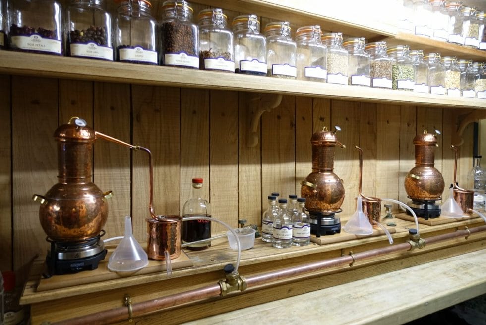 The gin lab with miniature stills and glass jars of botanicals