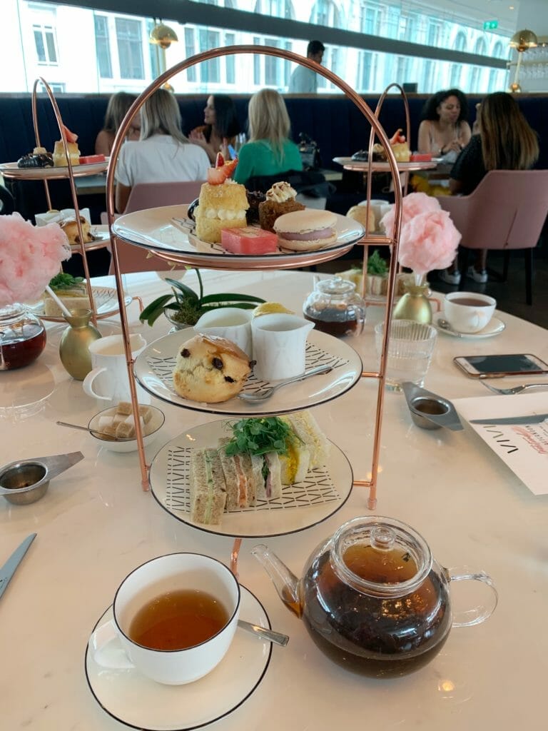 Cake stand full of afternoon tea treats and pot of tea at Vivi restaurant, Centre Point