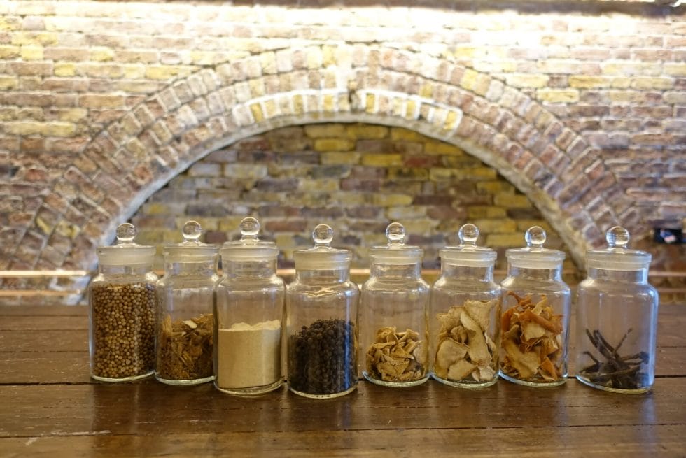 Jars of the 58 gin botanicals lined up on the bar 