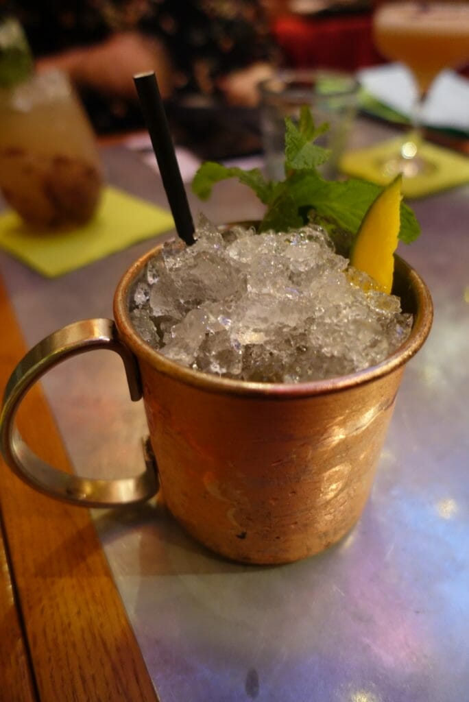 Julep cup with mint and mango poking out of the ice