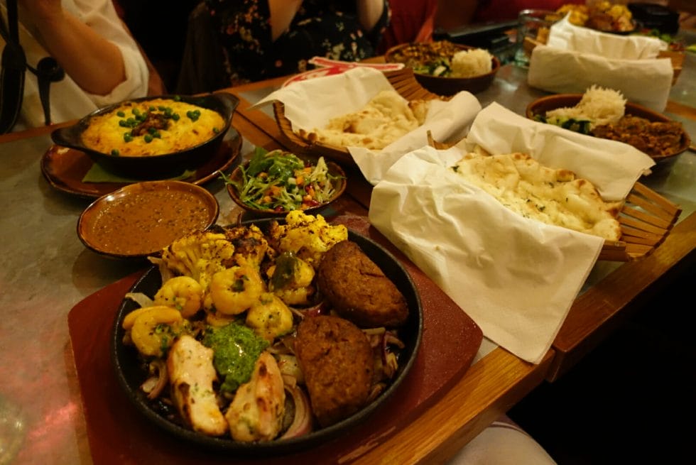 The table filled with main dishes and breads