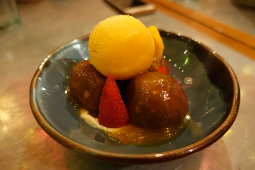 Passionfruit sorbet sitting on top of chocolate coated balls