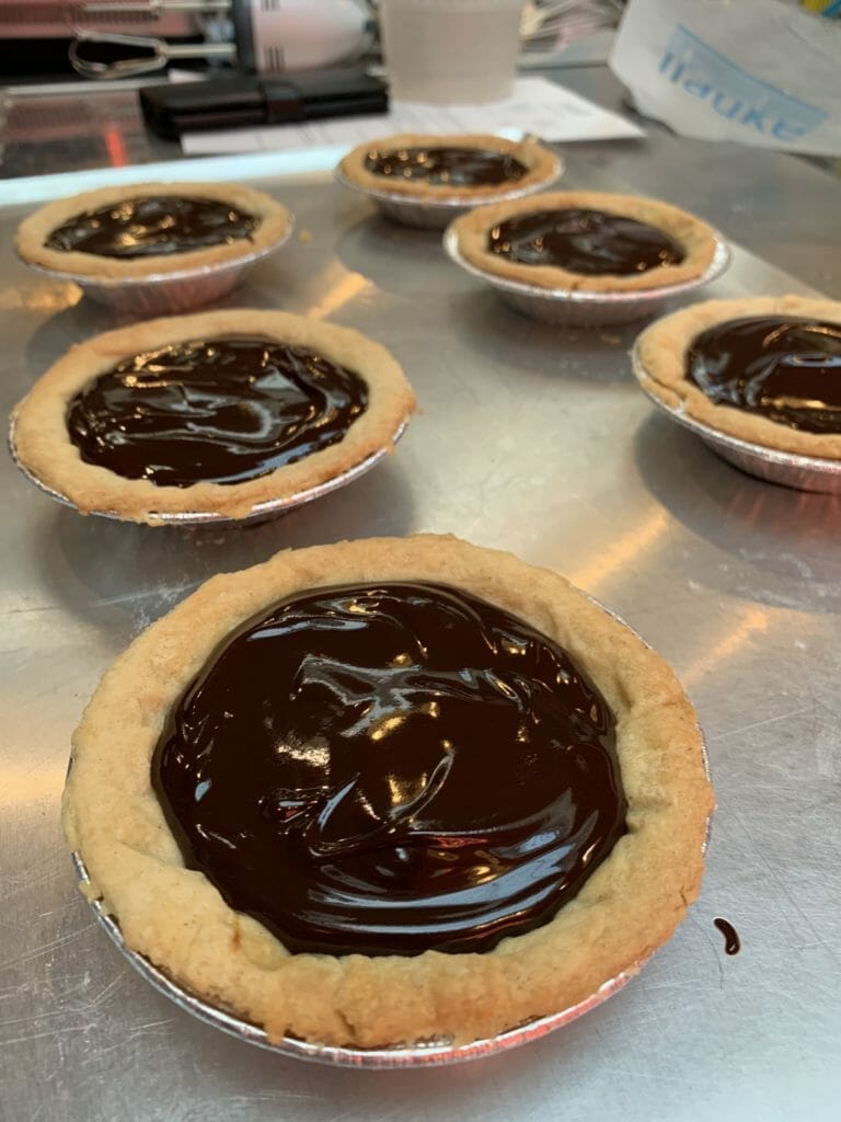 A tray of chocolate filled tarts