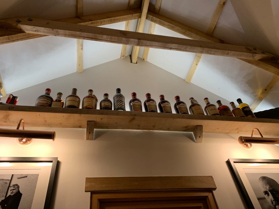 Drambuie bottles lined up in the eaves of the Skye Bothy