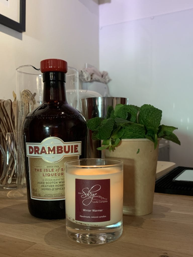 Drambuie bottle by candle and mint