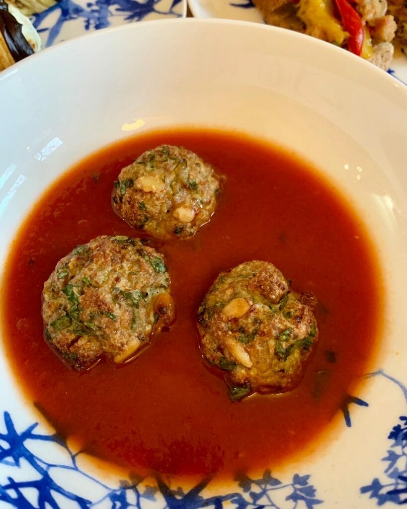 Meatballs sat in a bowl of tomato house
