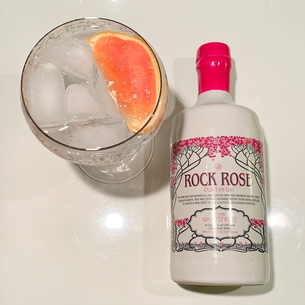 Flat lay of Rock Rose Pink Grapefruit gin bottle and gin and tonic