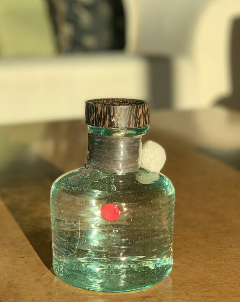 Procera red dot bottle on a table in the sun