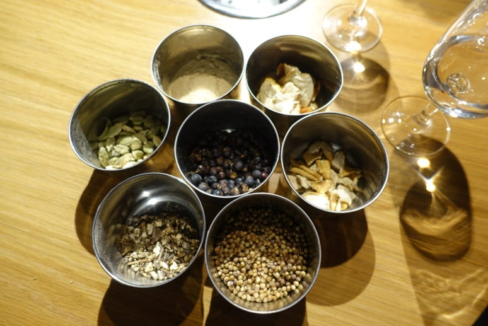 The seven botanicals in Plymouth gin and a tasting glass