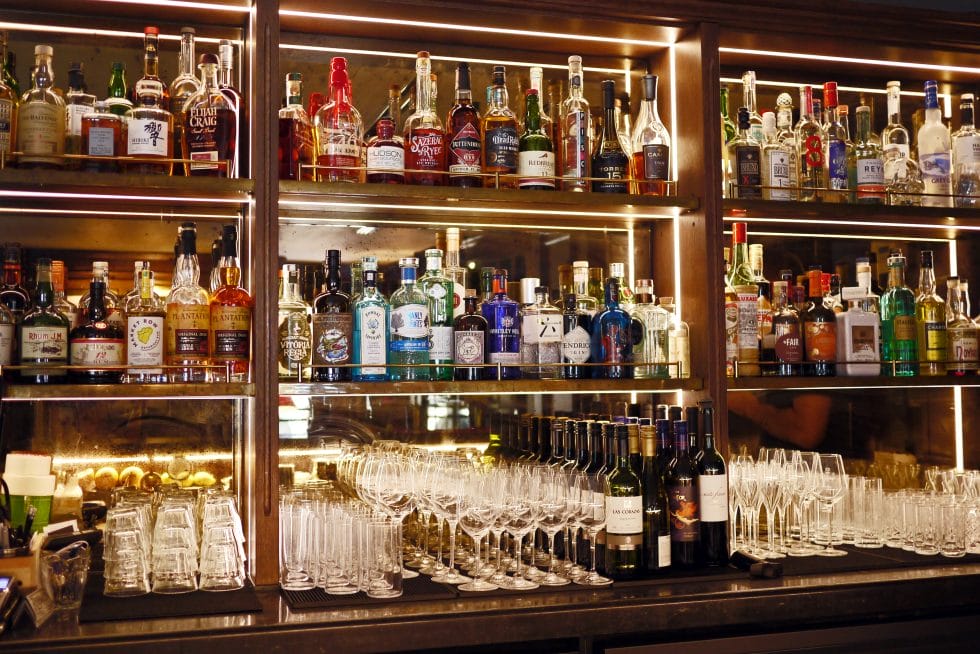 Backbar at Hensons in Soho with spirits and glasses on display