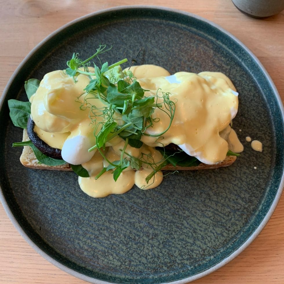 Eggs benedict with mushrooms and greens