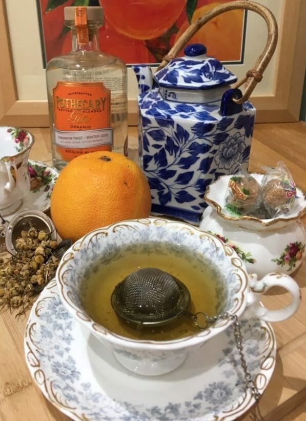 GIn and tea cocktail with tea pot served in a tea cup