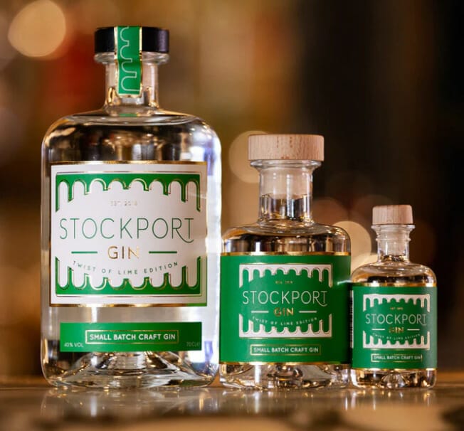 Trio of Stockport Lime gin bottles with green labels in descending size order